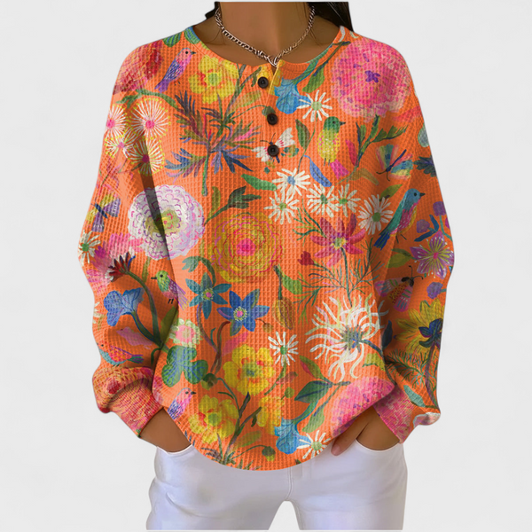 Women's orange floral print waffle jumper with colourful flowers and button neckline